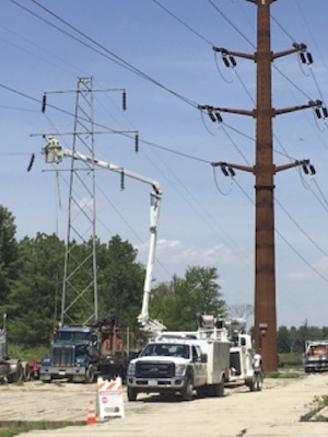 photo of transmission lines and a truck servicing them